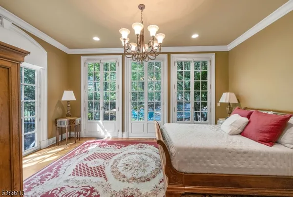 a bedroom with a large bed and a large window
