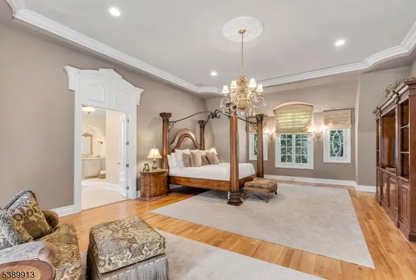 a living room with furniture a chandelier and a chandelier
