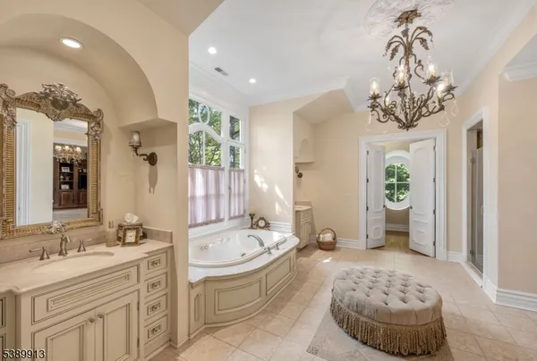 a bathroom with a tub sink and mirror