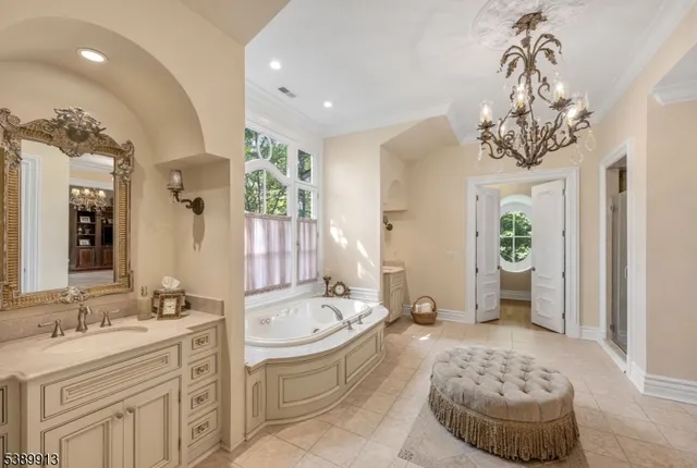 a bathroom with a tub sink and mirror