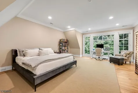 a spacious bedroom with a bed and large windows