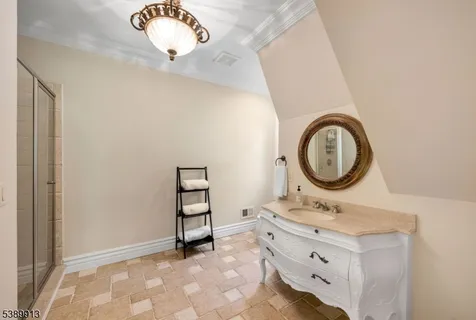 wooden bathroom with a sink and a mirror