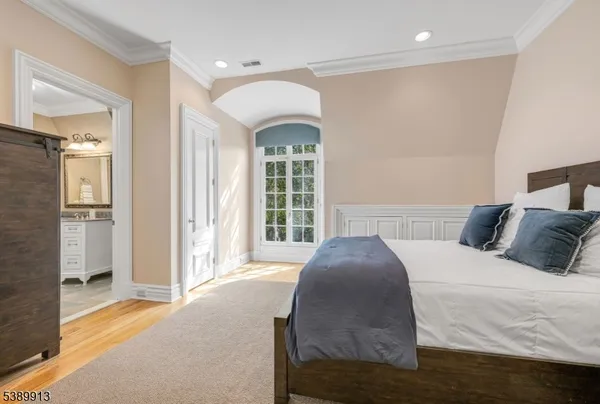 a spacious bedroom with a bed and a large window