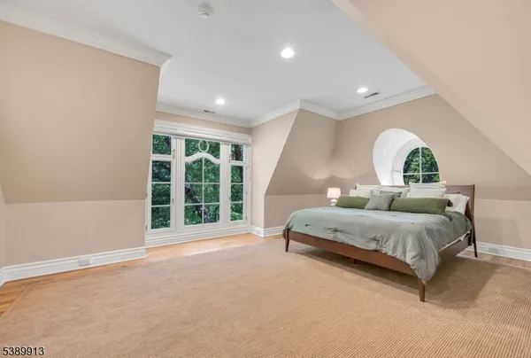 a spacious bedroom with a bed and window