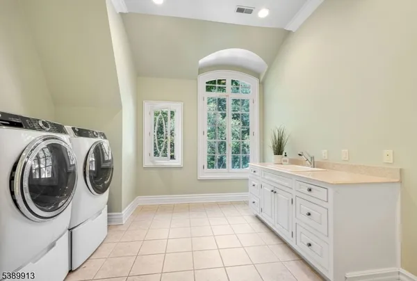a bathroom with a granite countertop sink a mirror and window