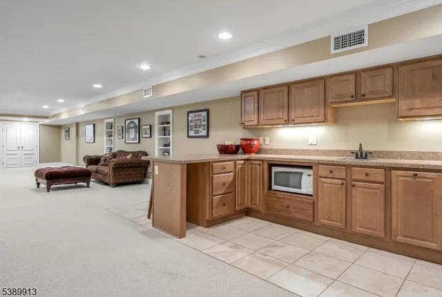 a kitchen with granite countertop a sink and cabinets