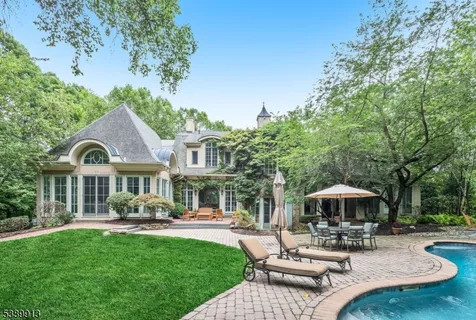 a patio with a table and chairs under an umbrella