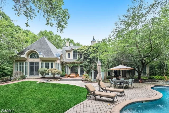 a patio with a table and chairs under an umbrella