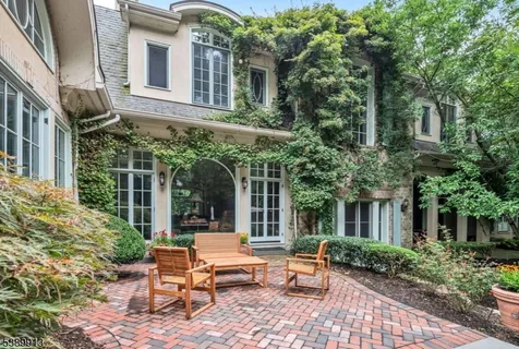 a view of a patio with table and chairs and potted plants