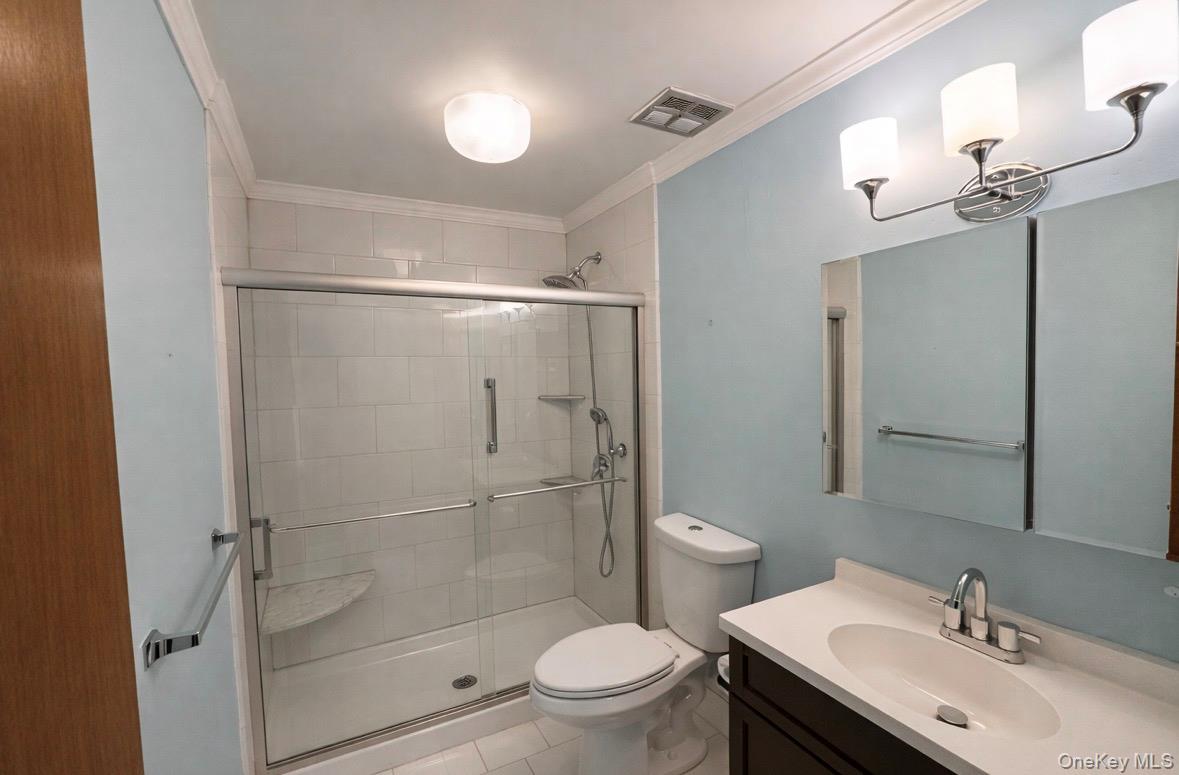 306 Torquay Court, Unit E Ridge, NY 11961 - Photo 11 of 12 a bathroom with a sink toilet and shower