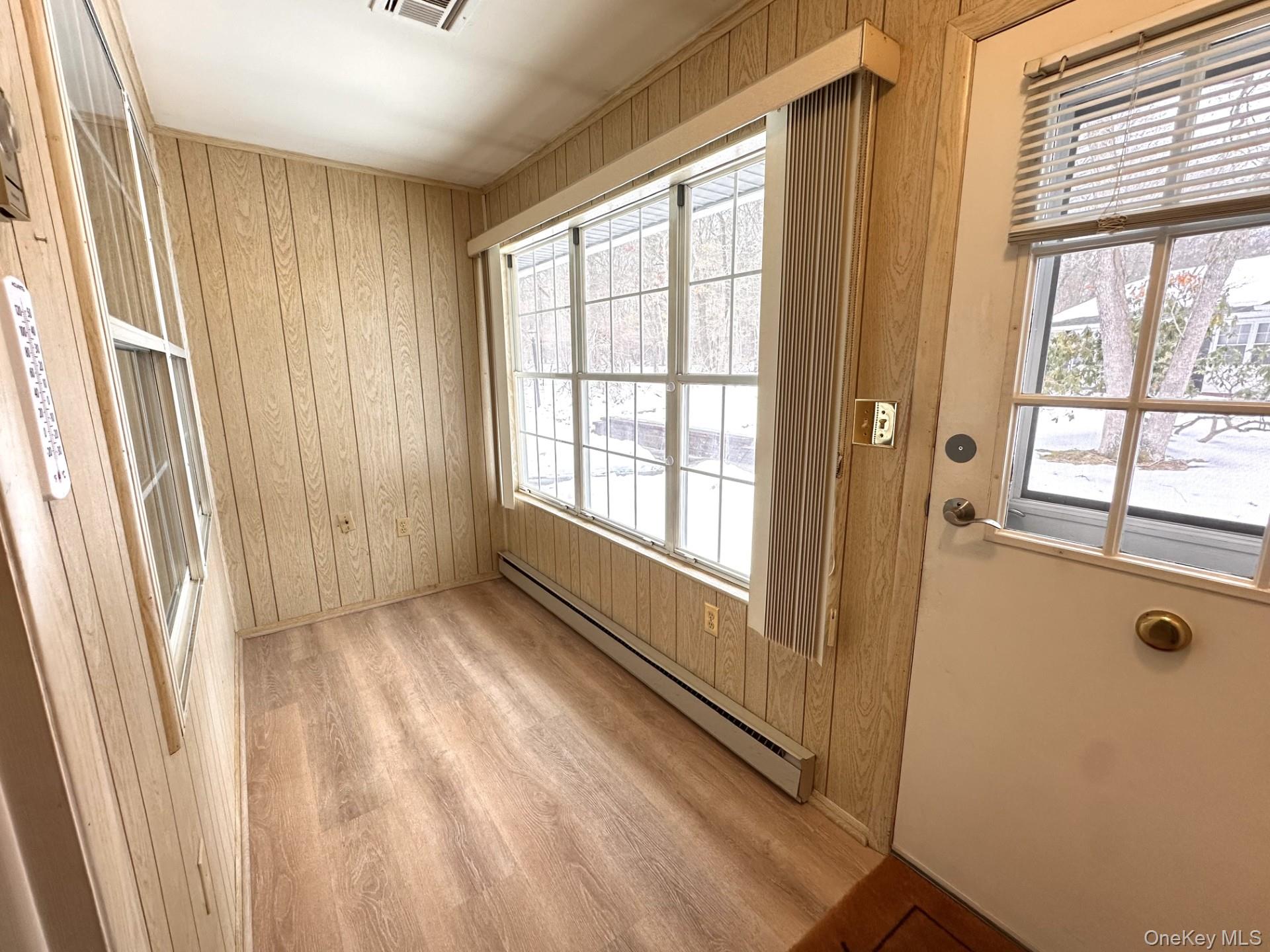306 Torquay Court, Unit E Ridge, NY 11961 - Photo 3 of 12 a view of an empty room with a window