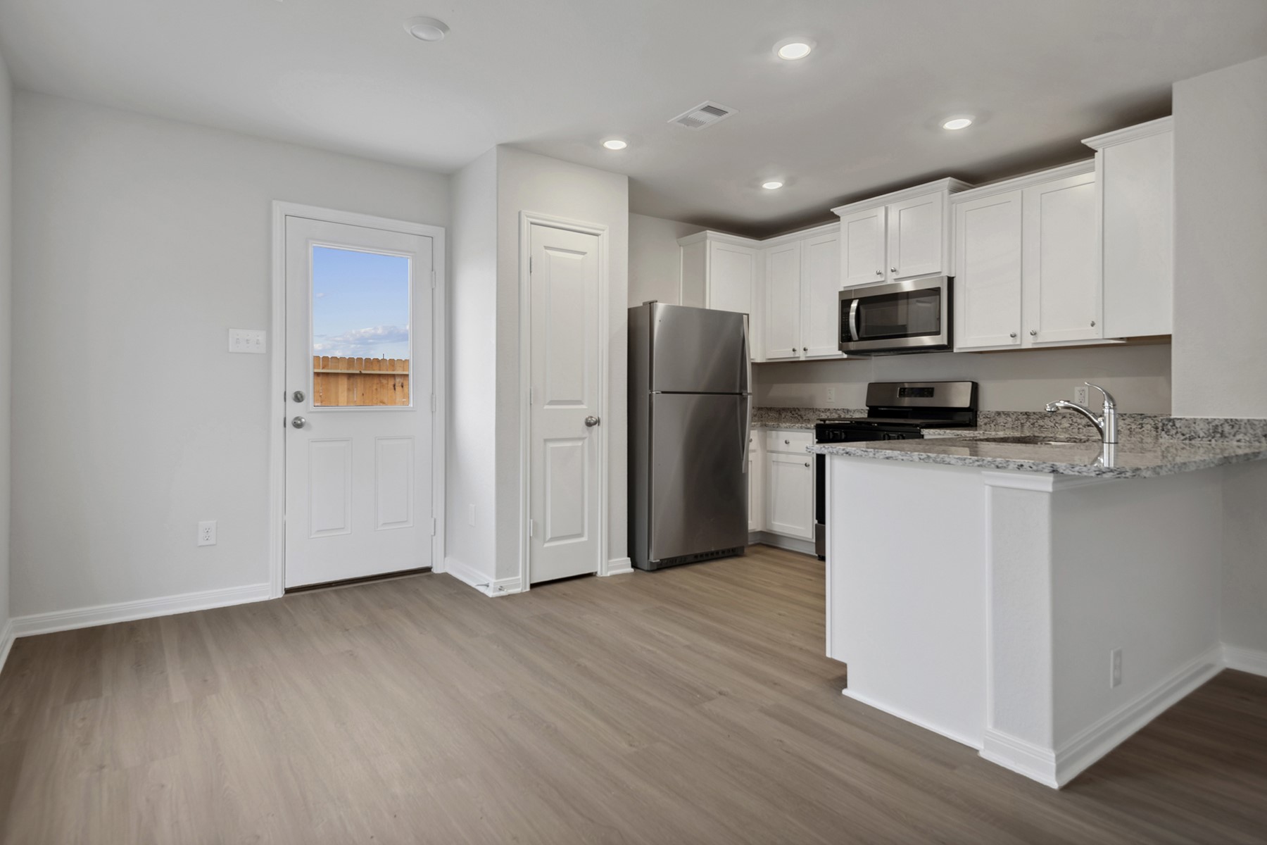 15866 Berry Hl Drive Conroe, TX 77303 - Photo 11 of 20 a kitchen with stainless steel appliances a refrigerator sink and microwave