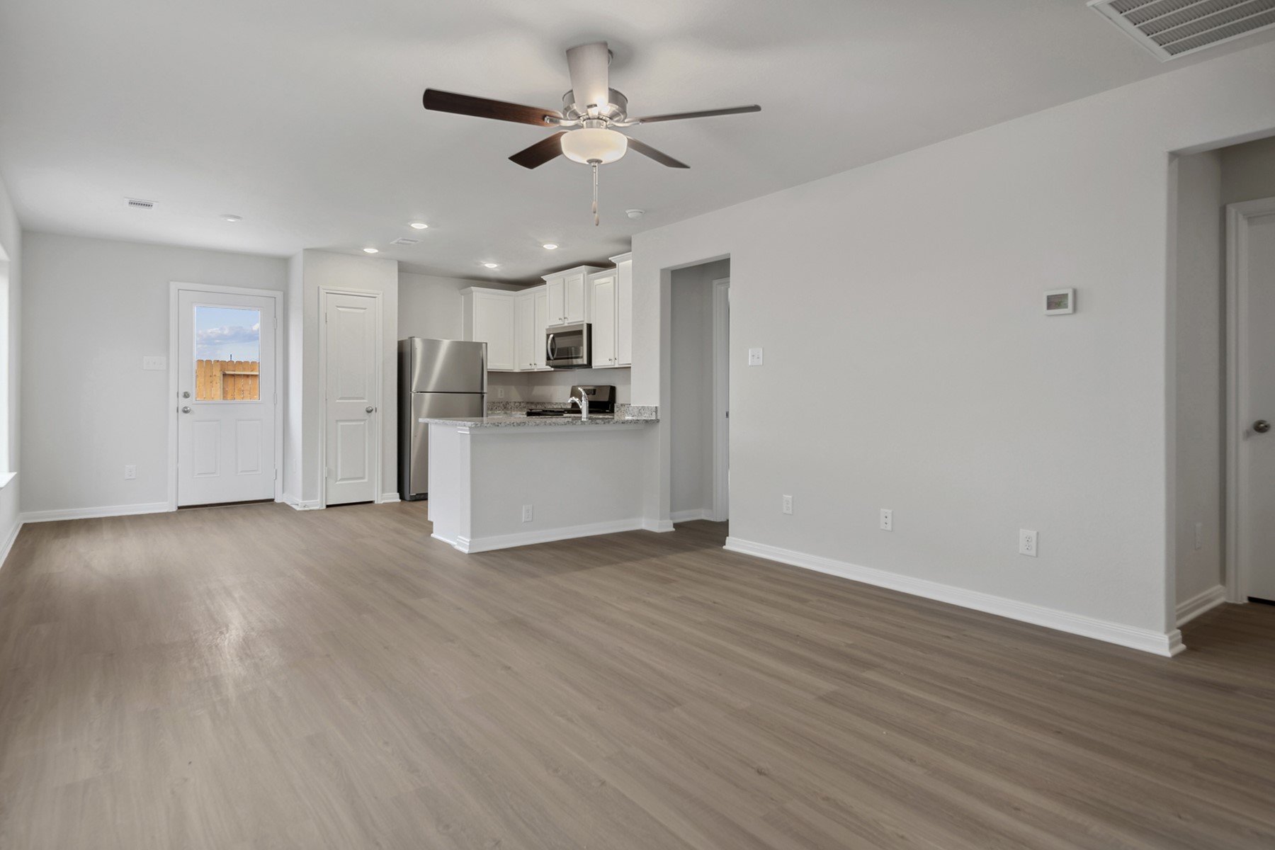 15866 Berry Hl Drive Conroe, TX 77303 - Photo 8 of 20 a view of a kitchen with a sink a refrigerator and wooden floor