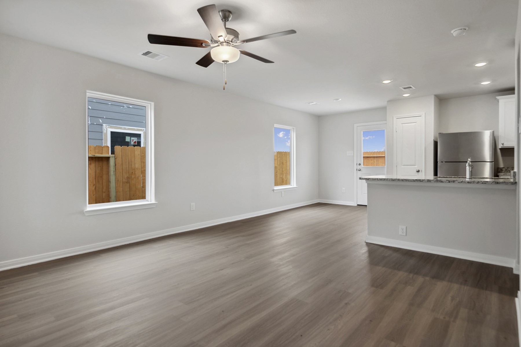 15866 Berry Hl Drive Conroe, TX 77303 - Photo 9 of 20 a view of an empty room with a window and wooden floor