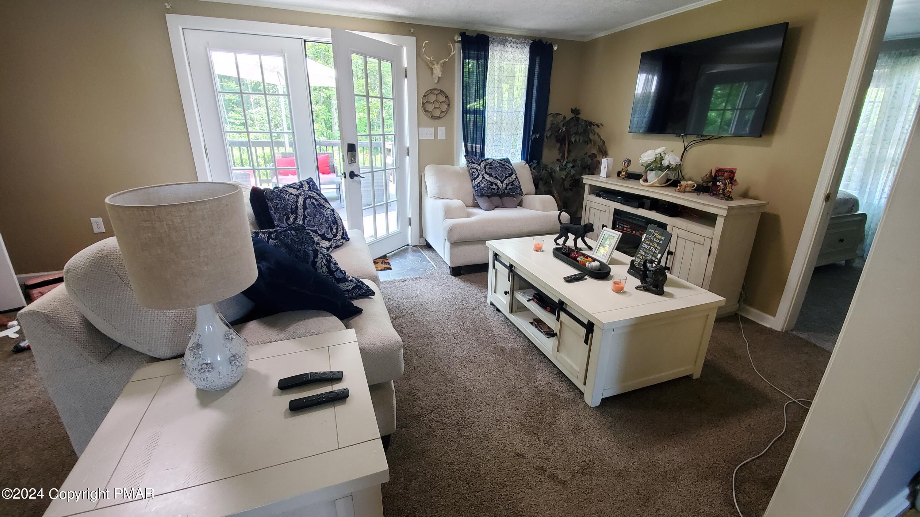 894 Spring Hill Road Sterling, PA 18463 - Photo 3 of 34 a living room with furniture and a flat screen tv