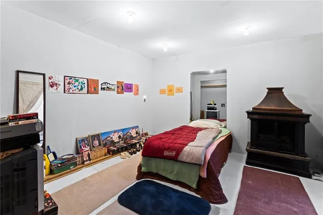 a bedroom with a bed and a fireplace