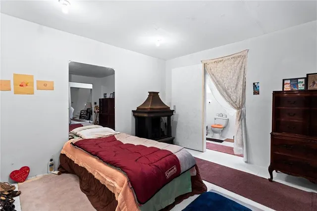 a bedroom with bed and wooden floor