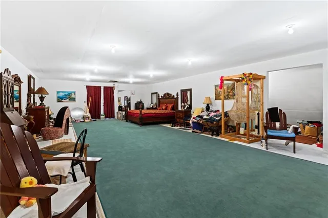 a living room with furniture a flat screen tv and gym equipment