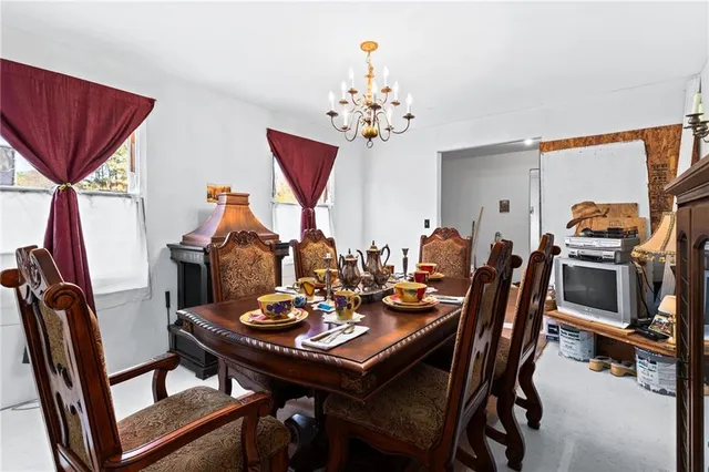 a view of a dining room with furniture and a chandelier