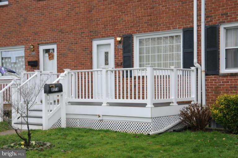 8173 Mid Haven Road Baltimore, MD 21222 - Photo 2 of 30 a view of a house with a small yard and wooden fence