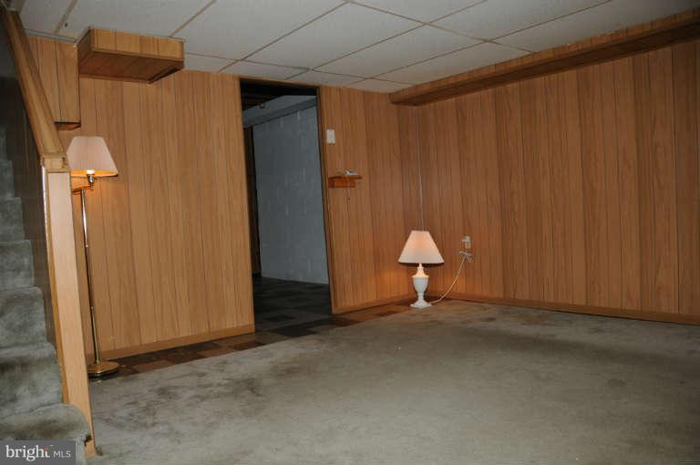 8173 Mid Haven Road Baltimore, MD 21222 - Photo 21 of 30 an empty room with closet and chandelier fan