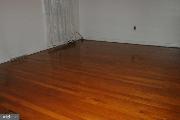 8173 Mid Haven Road Baltimore, MD 21222 - Photo 23 of 30 a view of room with wooden floor