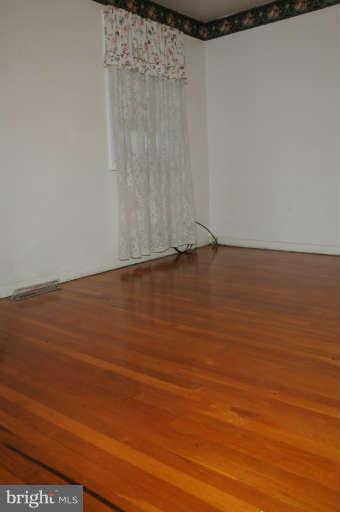 8173 Mid Haven Road Baltimore, MD 21222 - Photo 24 of 30 a view of an empty room with wooden floor