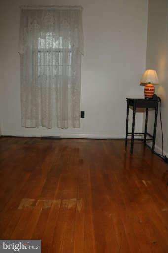 8173 Mid Haven Road Baltimore, MD 21222 - Photo 26 of 30 a view of room with window and wooden floor