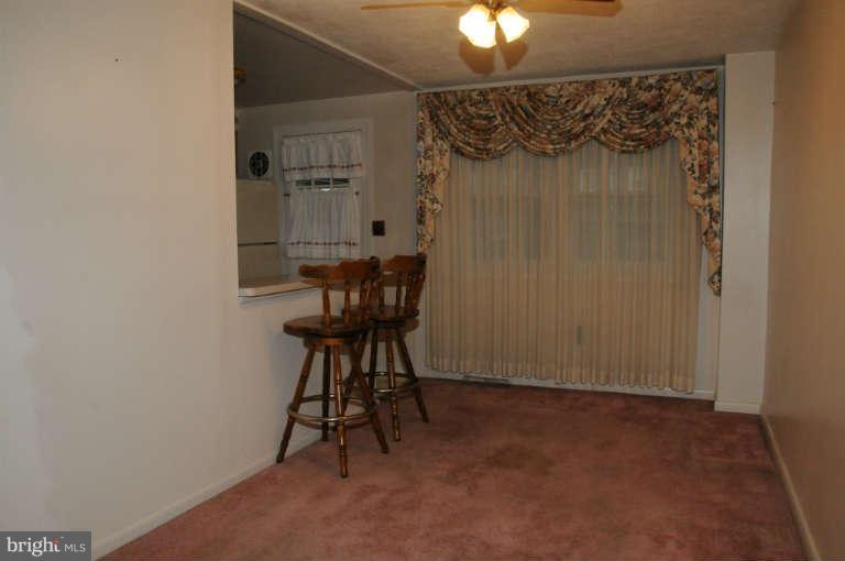 8173 Mid Haven Road Baltimore, MD 21222 - Photo 30 of 30 a view of a livingroom with furniture and a chandelier fan