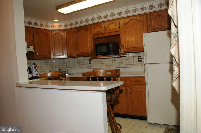 8173 Mid Haven Road Baltimore, MD 21222 - Photo 10 of 30 a kitchen with stainless steel appliances granite countertop a sink stove and refrigerator