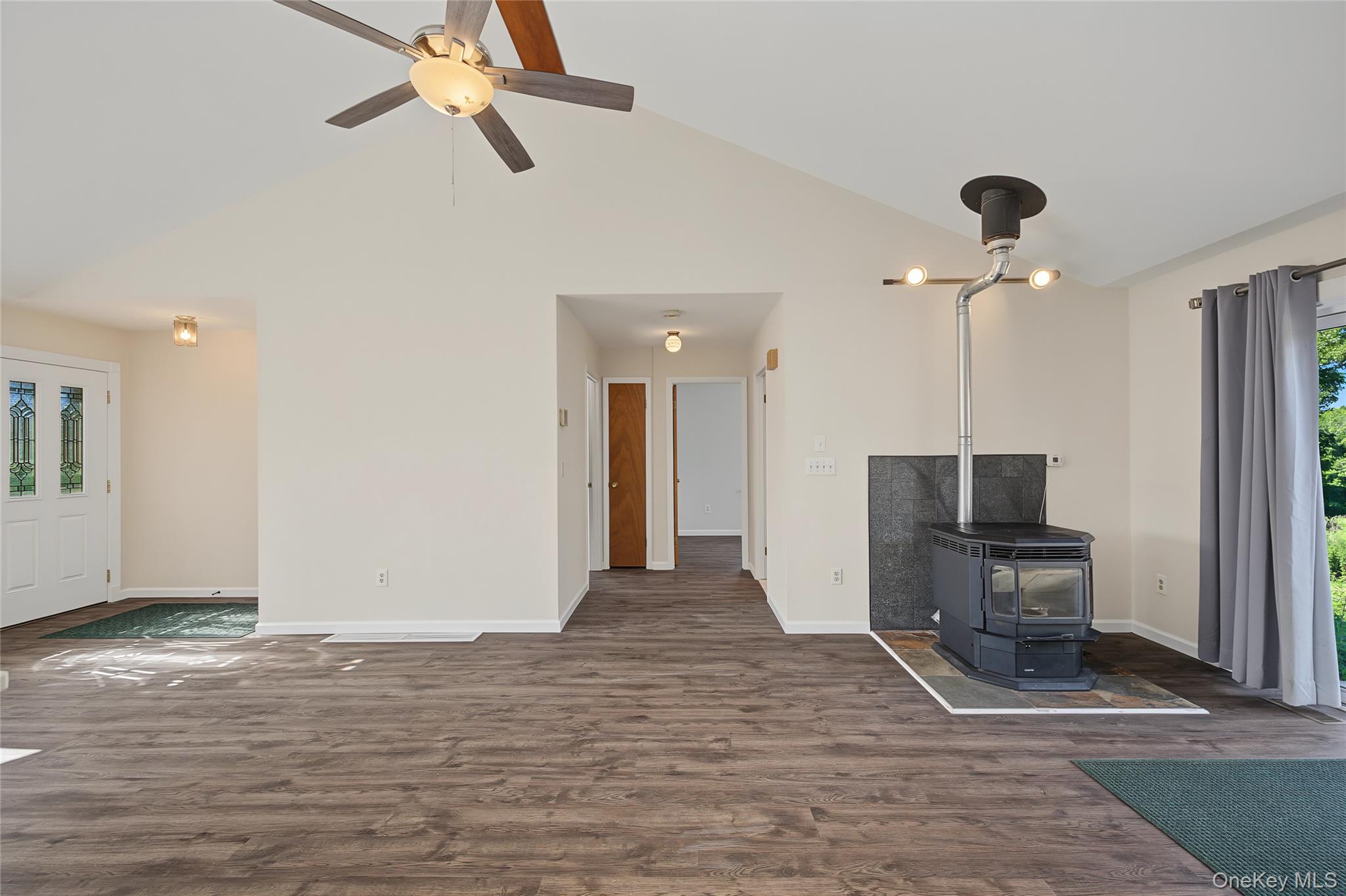 318 Cornwall Hill Road Patterson, NY 12563 - Photo 16 of 38 Living space featuring wood-finish flooring and a vaulted ceiling with a ceiling fan