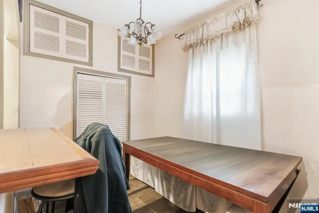 a view of a dining room with furniture and window