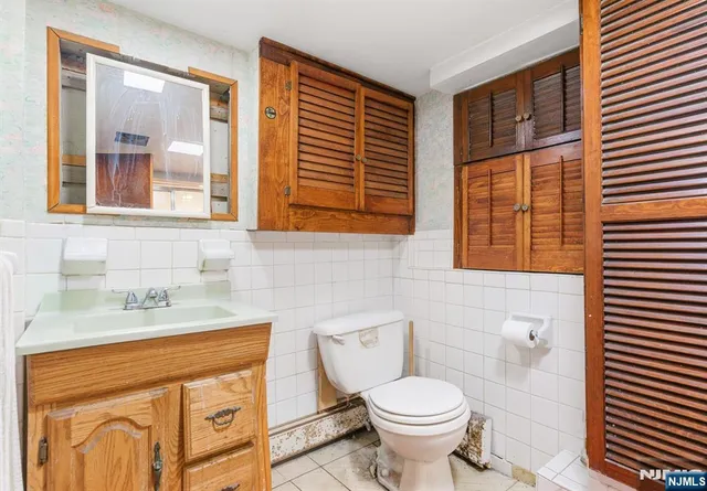 a bathroom with a sink a toilet and a window