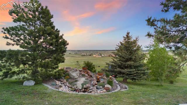 Yard at dusk featuring a rural view