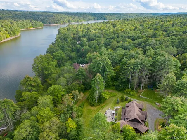 an aerial view of a houses with a lake view