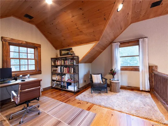 a view of a livingroom with lounge chair and a window