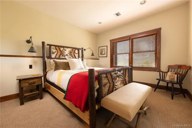 a bedroom with a bed a table and chair