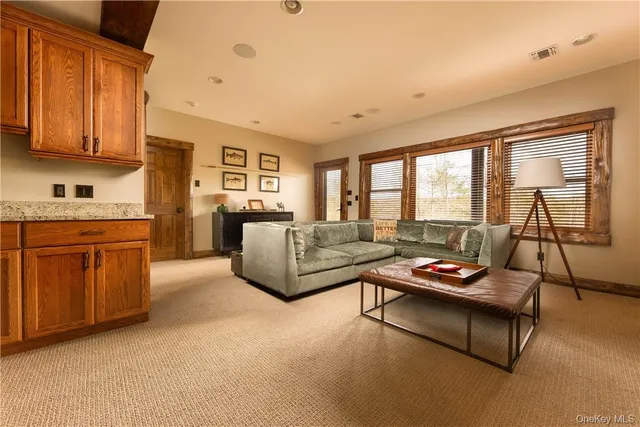 a living room with furniture and a open kitchen area