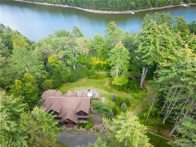 an aerial view of a house with a yard swimming pool and outdoor seating