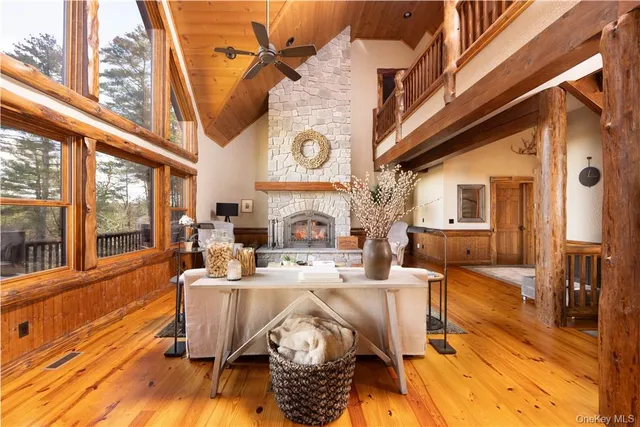 a view of a dining room with furniture a chandelier and wooden floor