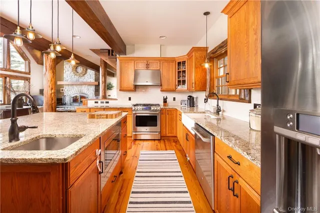 a kitchen with stainless steel appliances granite countertop a sink and a stove