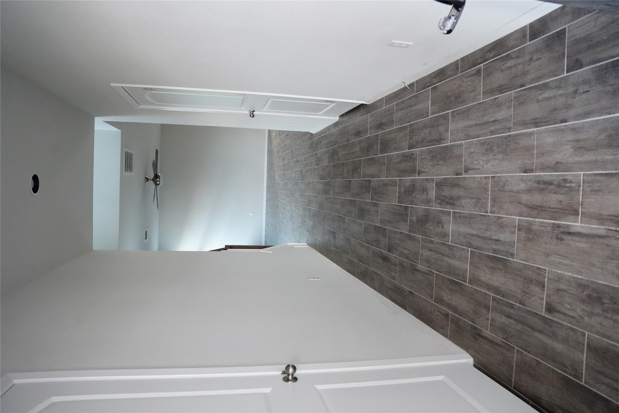 117 Crescent Street Georgetown, TX 78626 - Photo 15 of 38 A long, inviting hallway with wood-look tile flooring leads to a spacious area beyond.