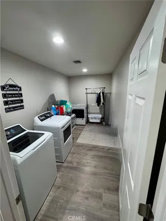 a view of storage and utility room with washer and dryer