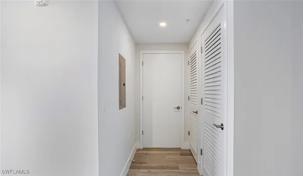 a view of a hallway with wooden floor