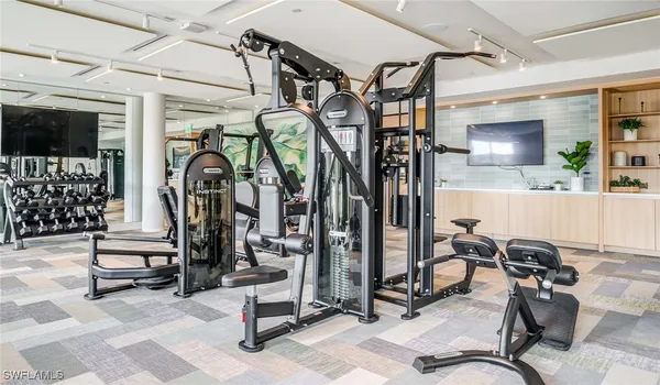 a view of a room with gym equipment and windows