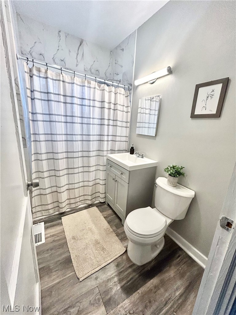 2563 Overlook Road Cleveland, OH 44106 - Photo 12 of 32 Bathroom with vanity, toilet, and hardwood / wood-style floors