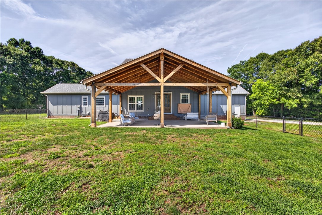 5016 Copeland Road Belton, SC 29627 - Photo 36 of 45 An inviting covered patio with an exposed beam ceiling creates an ideal outdoor living space for relaxation and entertaining.