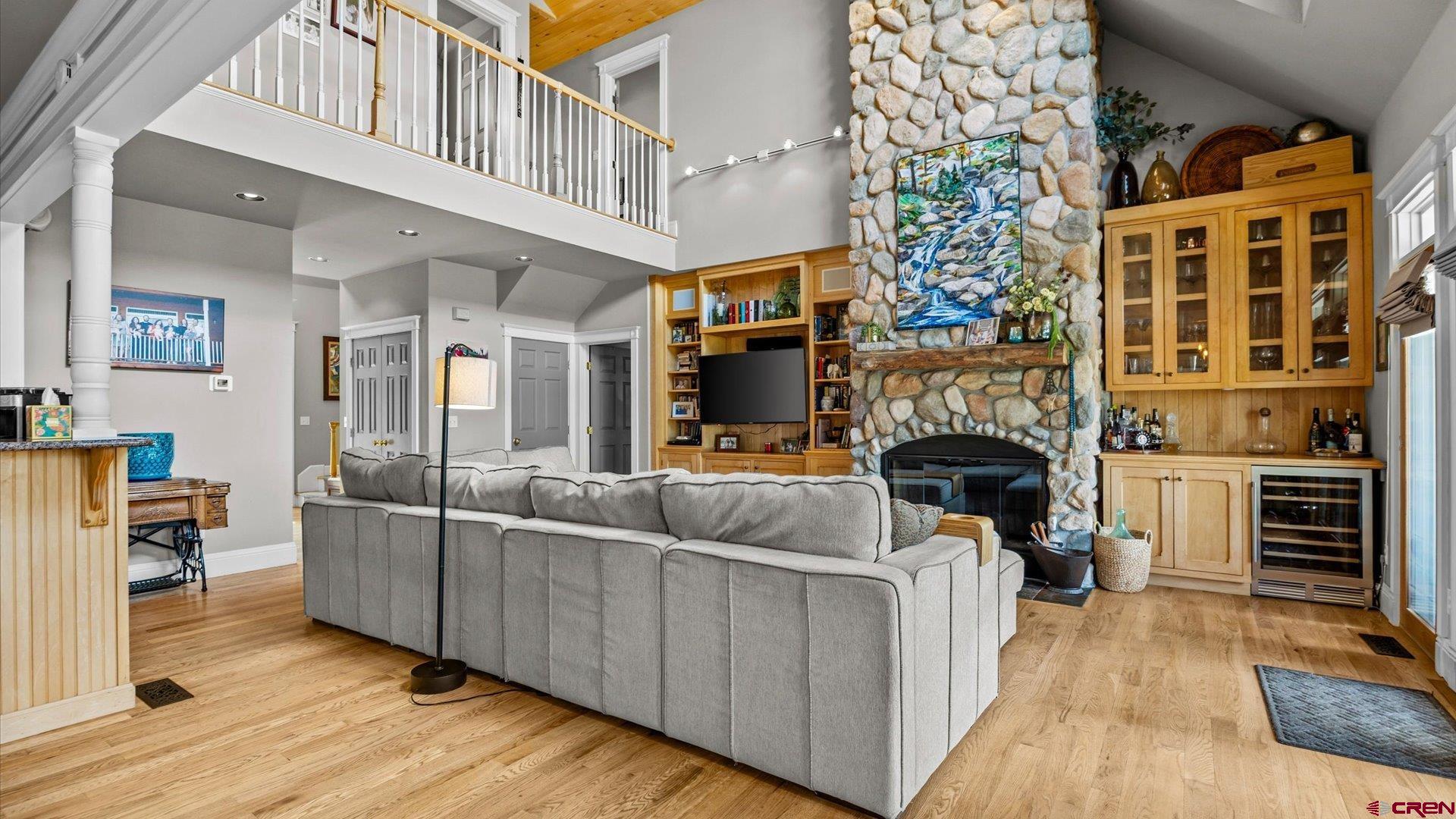 269 Puma Lane Ridgway, CO 81432 - Photo 12 of 36 a living room with furniture a fireplace and a dining table with wooden floor