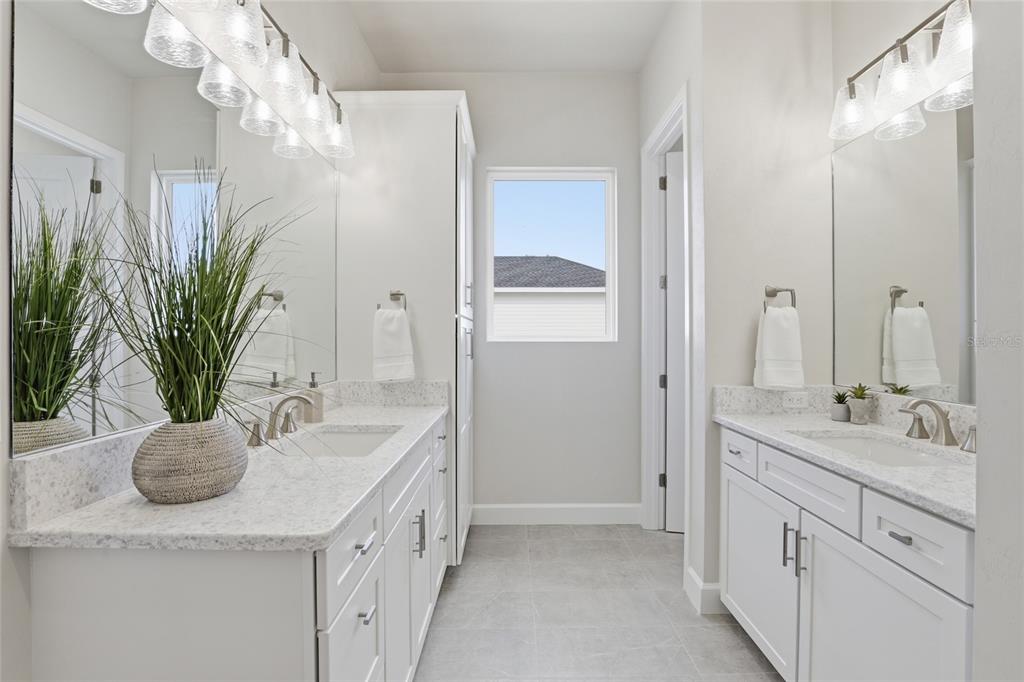 13425 Southwest 9th Road Newberry, FL 32669 - Photo 16 of 46 a bathroom with a granite countertop sink a large mirror a vanity and a shower