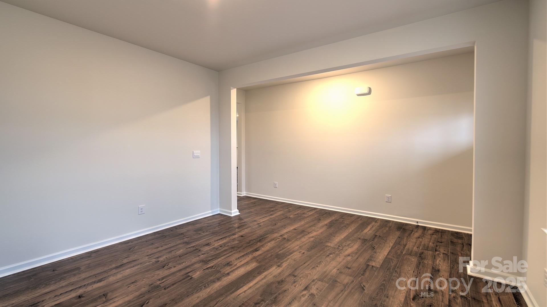 356 Wheatfield Road Fletcher, NC 28732 - Photo 9 of 25 a view of an empty room with wooden floor and a window